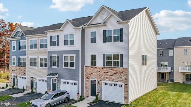 178 Munsee Cir, Winchester, VA 22602 - townhome / multi-family property with stone siding, a garage, driveway, and a front yard