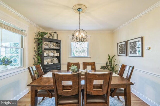 614 Radnor Ave, Haddonfield, NJ 08033 - dining area featuring a chandelier, light wood-style floors, and ornamental molding
