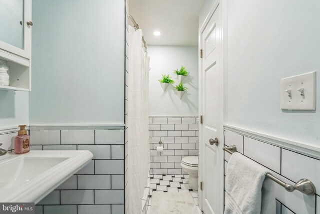 614 Radnor Ave, Haddonfield, NJ 08033 - bathroom featuring tile walls, a wainscoted wall, and curtained shower