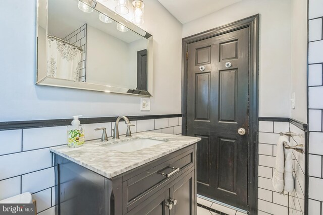 614 Radnor Ave, Haddonfield, NJ 08033 - full bathroom with tile walls, vanity, wainscoting, and tile patterned flooring