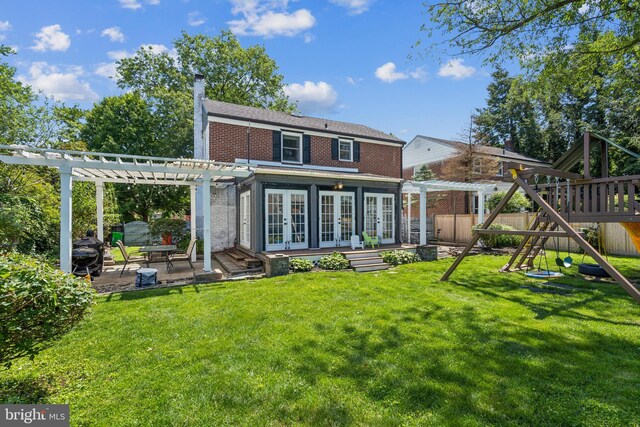 614 Radnor Ave, Haddonfield, NJ 08033 - back of property featuring french doors, a pergola, a playground, and brick siding