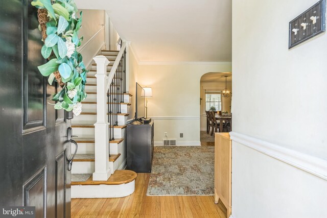 614 Radnor Ave, Haddonfield, NJ 08033 - foyer entrance featuring arched walkways, wood finished floors, stairway, and crown molding