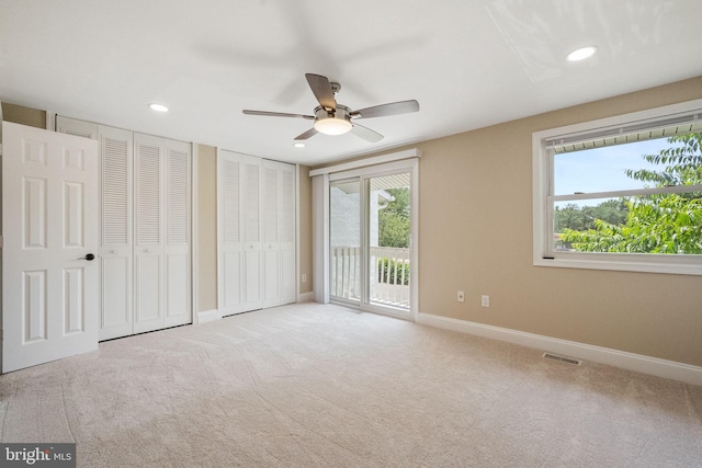 86 Sugarland Run Dr, Sterling, VA 20164 - unfurnished bedroom featuring access to exterior, multiple closets, multiple windows, carpet, and recessed lighting