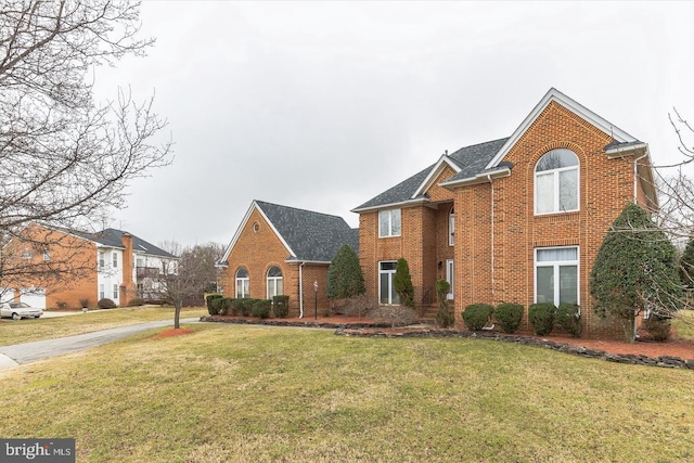 8305 Gullane Ct, Fort Washington, MD 20744 - view of front of house with brick siding, a front lawn, and roof with shingles