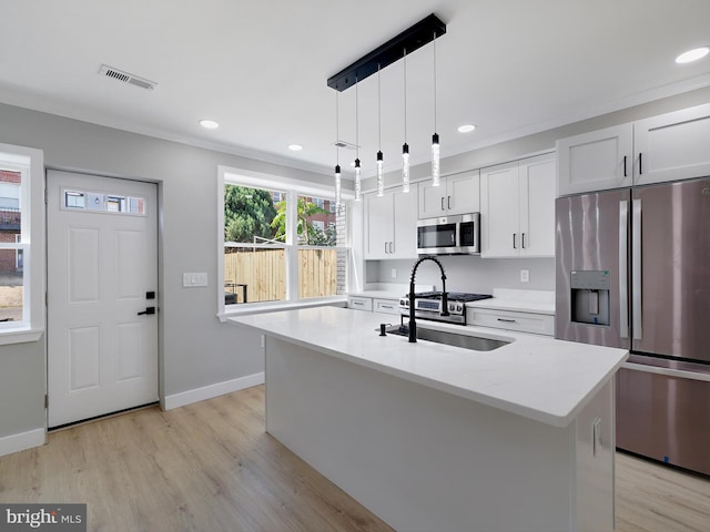 1759 Lyman Pl NE, Washington, DC 20002 - kitchen featuring stainless steel appliances, crown molding, light wood-style floors, recessed lighting, and an island with sink