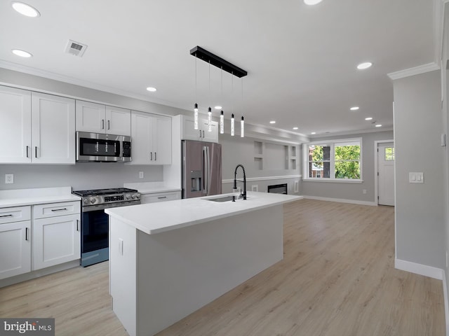 1759 Lyman Pl NE, Washington, DC 20002 - kitchen featuring stainless steel appliances, ornamental molding, recessed lighting, a kitchen island with sink, and light countertops