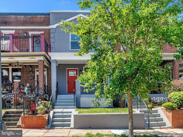 1759 Lyman Pl NE, Washington, DC 20002 - view of property featuring brick siding, a porch, a balcony, and stairs