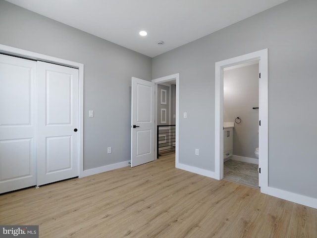 1759 Lyman Pl NE, Washington, DC 20002 - unfurnished bedroom featuring light wood-type flooring, a closet, and connected bathroom