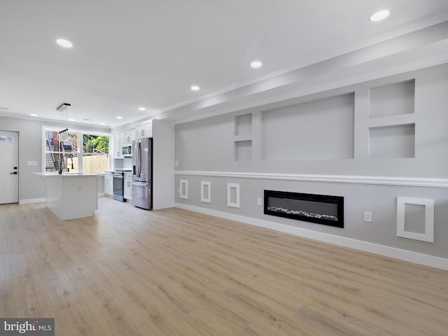 1759 Lyman Pl NE, Washington, DC 20002 - unfurnished living room with light wood-style flooring, recessed lighting, crown molding, a glass covered fireplace, and built in shelves