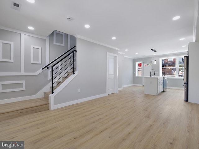 1759 Lyman Pl NE, Washington, DC 20002 - unfurnished living room with light wood finished floors, stairway, recessed lighting, and crown molding