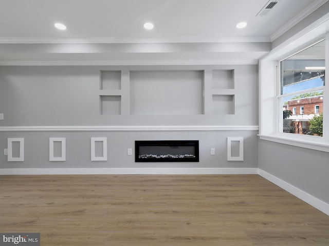 1759 Lyman Pl NE, Washington, DC 20002 - unfurnished living room featuring ornamental molding, a glass covered fireplace, wood finished floors, recessed lighting, and built in features