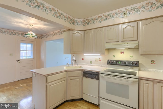 811 S Harrison St, Palmyra, PA 17078 - kitchen with white appliances, under cabinet range hood, light countertops, and a peninsula