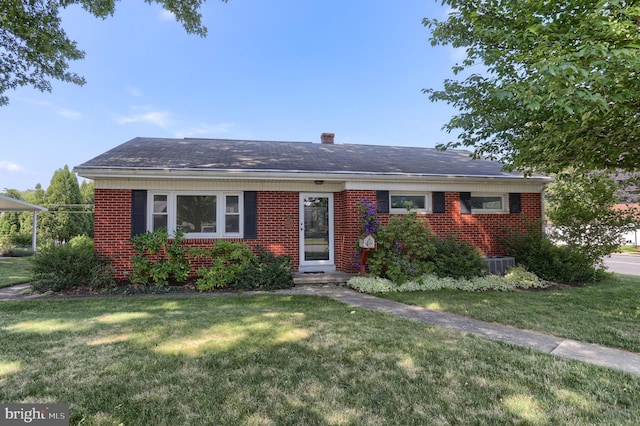 811 S Harrison St, Palmyra, PA 17078 - view of front facade featuring a front yard, brick siding, and a chimney