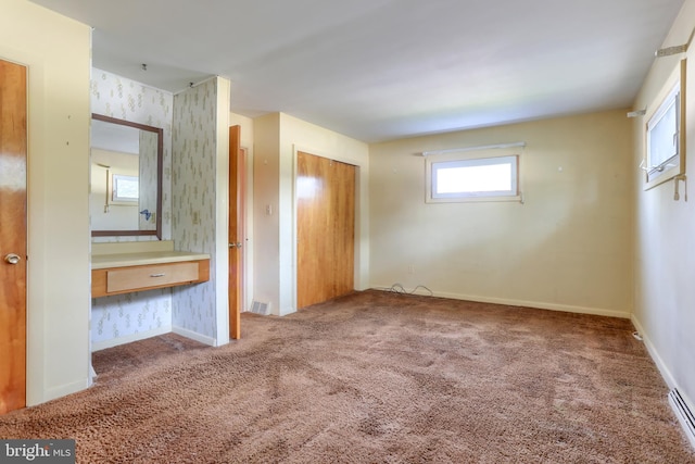 811 S Harrison St, Palmyra, PA 17078 - unfurnished bedroom featuring carpet, wallpapered walls, a closet, an office area, and baseboard heating