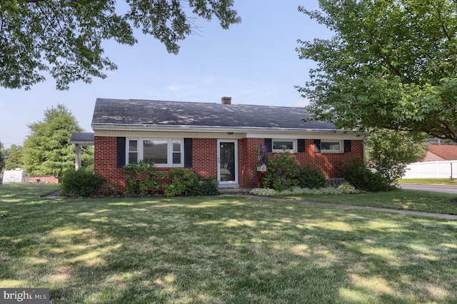 811 S Harrison St, Palmyra, PA 17078 - view of front facade with brick siding, a front lawn, a chimney, and a shingled roof
