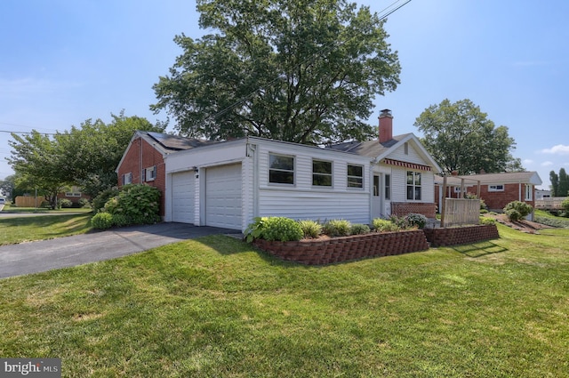 811 S Harrison St, Palmyra, PA 17078 - view of front of home featuring brick siding, a chimney, a front yard, asphalt driveway, and an attached garage