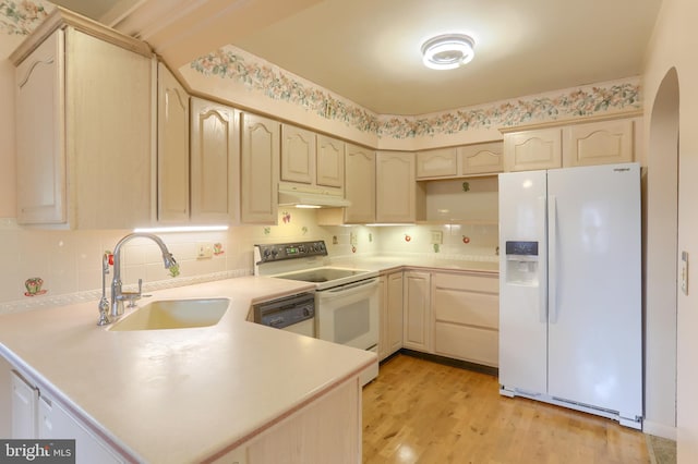 811 S Harrison St, Palmyra, PA 17078 - kitchen featuring white appliances, a peninsula, arched walkways, under cabinet range hood, and light brown cabinets
