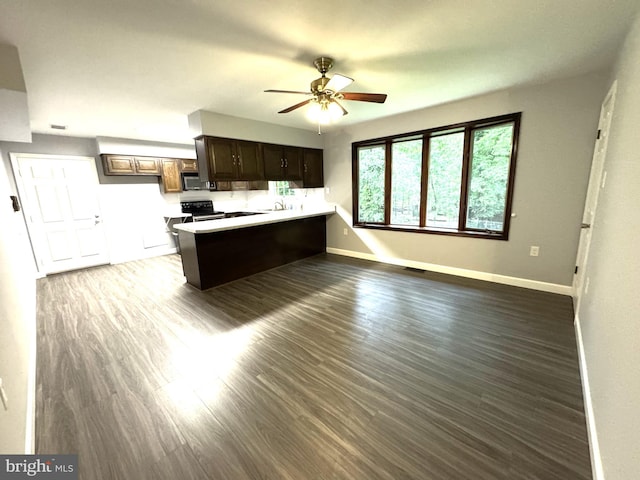 16611 Summers Ln, Brandywine, MD 20613 - kitchen with stainless steel microwave, a peninsula, a ceiling fan, dark wood finished floors, and light countertops
