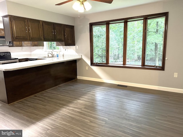 16611 Summers Ln, Brandywine, MD 20613 - kitchen featuring appliances with stainless steel finishes, a peninsula, ceiling fan, dark wood finished floors, and dark brown cabinetry