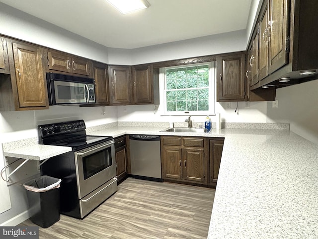 16611 Summers Ln, Brandywine, MD 20613 - kitchen with stainless steel appliances, light countertops, and dark brown cabinets