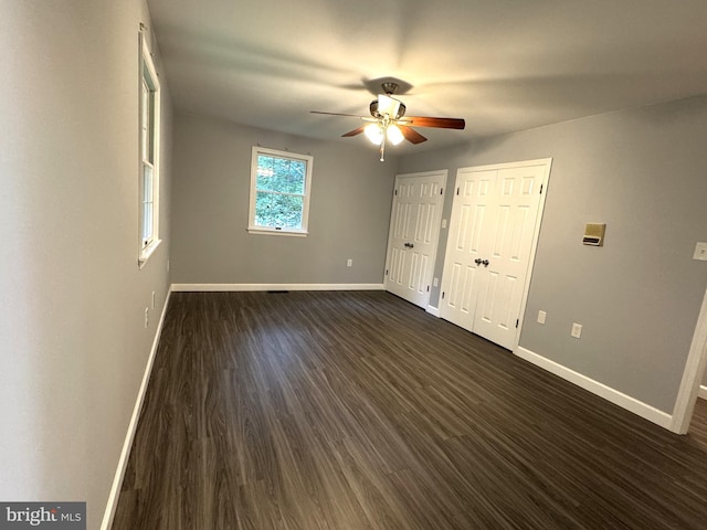 16611 Summers Ln, Brandywine, MD 20613 - unfurnished bedroom with dark wood-style flooring, multiple closets, and a ceiling fan