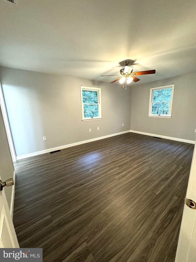 16611 Summers Ln, Brandywine, MD 20613 - unfurnished room featuring dark wood-type flooring, healthy amount of natural light, and a ceiling fan