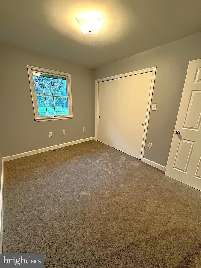 16611 Summers Ln, Brandywine, MD 20613 - unfurnished bedroom featuring dark carpet and a closet