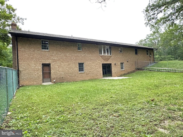 16611 Summers Ln, Brandywine, MD 20613 - back of house with a chimney and brick siding