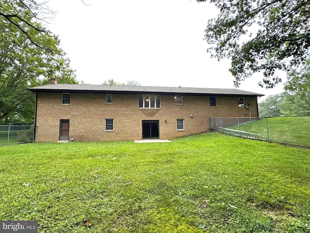 16611 Summers Ln, Brandywine, MD 20613 - back of property featuring a fenced backyard, a chimney, and brick siding