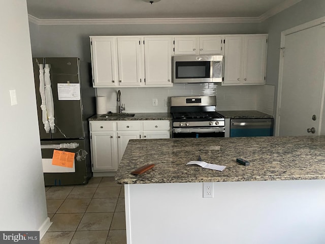 4214 Labyrinth Rd, Baltimore, MD 21215 - kitchen with stainless steel appliances, white cabinets, tasteful backsplash, and ornamental molding