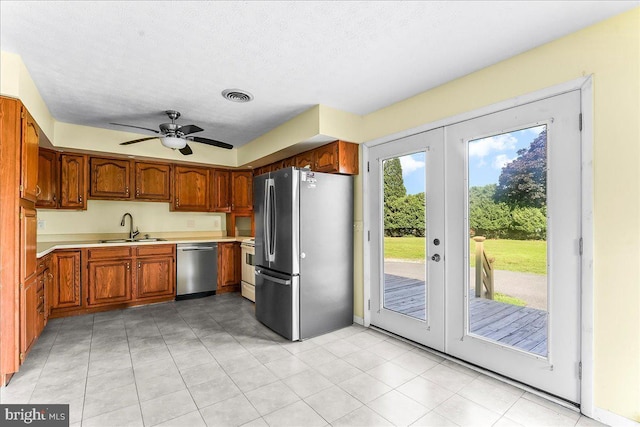158 Firetower Rd, Port Deposit, MD 21904 - kitchen with stainless steel appliances, light countertops, french doors, brown cabinetry, and a ceiling fan