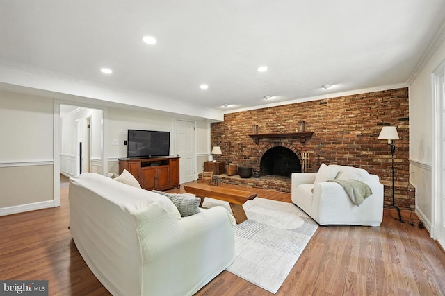 8201 Briar Creek Dr, Annandale, VA 22003 - living room with wood finished floors, a brick fireplace, crown molding, recessed lighting, and brick wall
