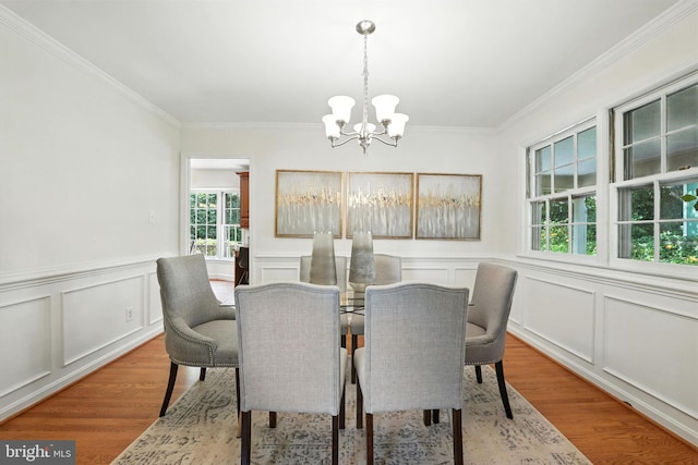 8201 Briar Creek Dr, Annandale, VA 22003 - dining space with a chandelier, crown molding, light wood-type flooring, a decorative wall, and wainscoting