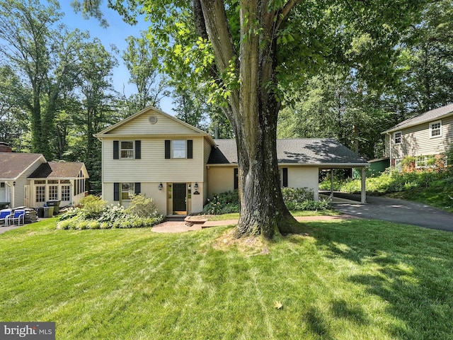 8201 Briar Creek Dr, Annandale, VA 22003 - split level home with asphalt driveway, a front yard, and an attached carport