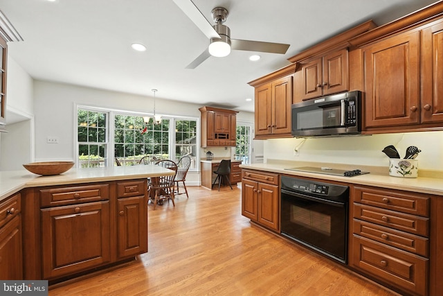 8201 Briar Creek Dr, Annandale, VA 22003 - kitchen with black appliances, ceiling fan, light wood-style floors, light countertops, and recessed lighting