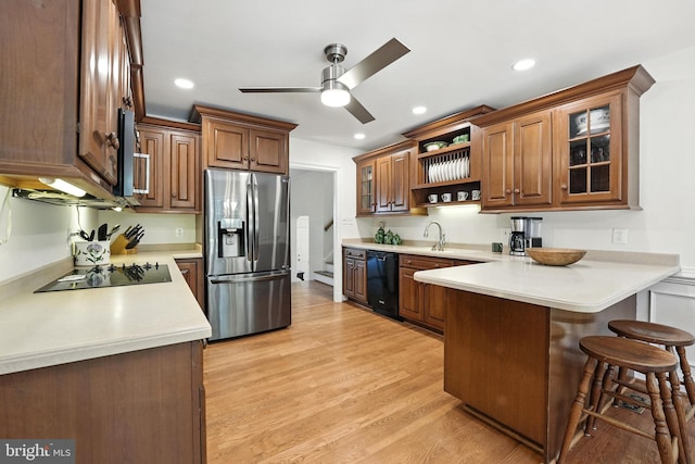 8201 Briar Creek Dr, Annandale, VA 22003 - kitchen with black appliances, a peninsula, open shelves, a kitchen bar, and a ceiling fan