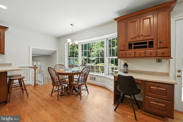 8201 Briar Creek Dr, Annandale, VA 22003 - dining area with light wood-style floors, built in study area, and a chandelier