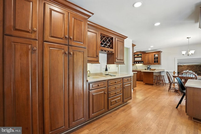 8201 Briar Creek Dr, Annandale, VA 22003 - kitchen with brown cabinets, light wood finished floors, hanging light fixtures, light countertops, and recessed lighting