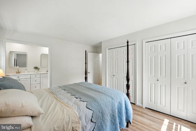 8201 Briar Creek Dr, Annandale, VA 22003 - bedroom featuring two closets, light wood-style floors, and ensuite bathroom