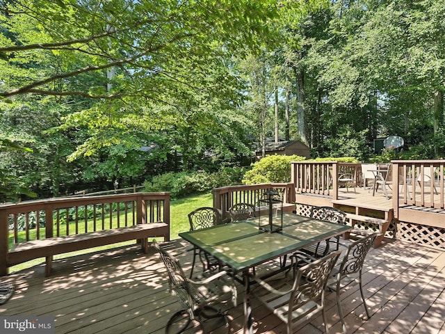 8201 Briar Creek Dr, Annandale, VA 22003 - deck with outdoor dining space, view of scattered trees, and a lawn