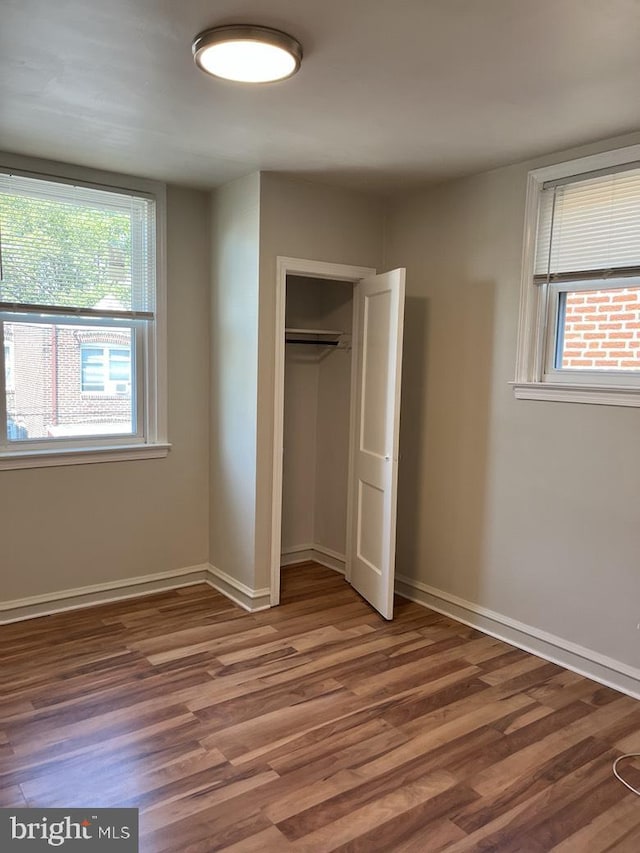 3019 Magee Ave, Philadelphia, PA 19149 - unfurnished bedroom featuring multiple windows, wood finished floors, and a closet