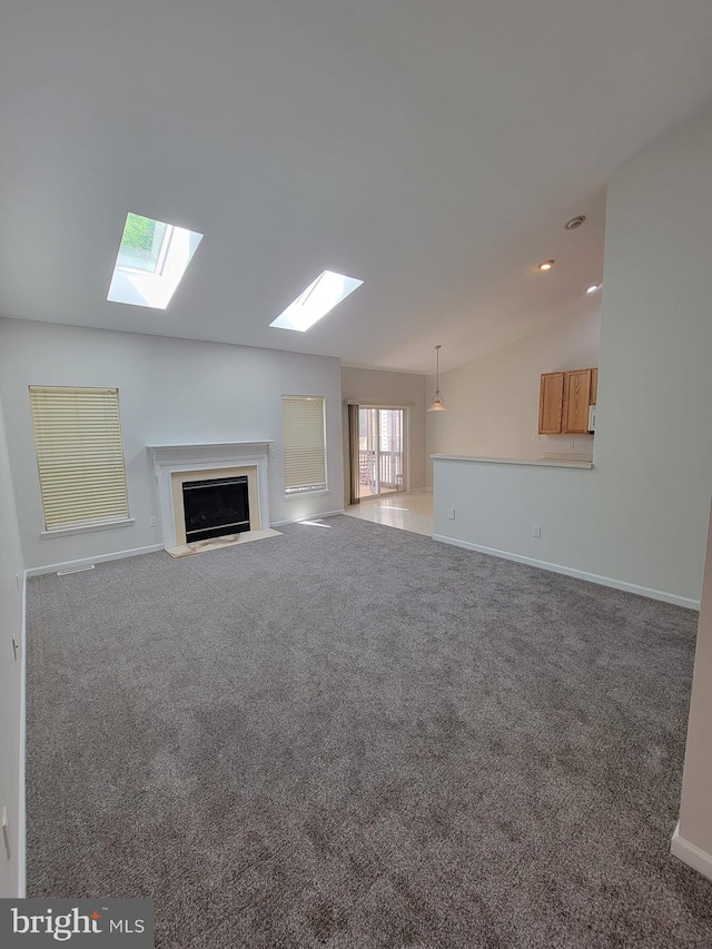 29 Hearthstone Blvd, Pemberton, NJ 08068 - unfurnished living room featuring a skylight, lofted ceiling, a fireplace with flush hearth, and carpet flooring