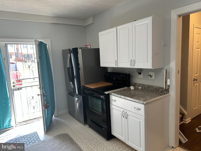 95 Buchanan Ln, Inwood, WV 25428 - kitchen with black range with electric cooktop, white cabinetry, freestanding refrigerator, light flooring, and light stone counters