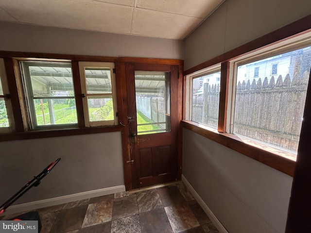 135-137 S 6th St, Shamokin, PA 17872 - doorway to outside featuring baseboards and dark stone finish floors