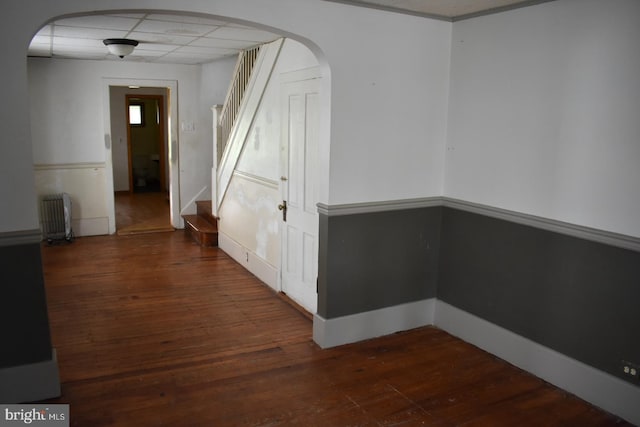 135-137 S 6th St, Shamokin, PA 17872 - corridor featuring radiator heating unit, stairs, dark wood-style flooring, and arched walkways