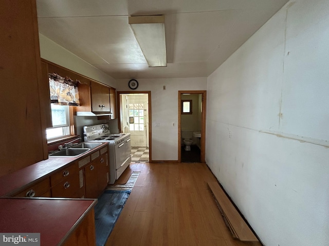 135-137 S 6th St, Shamokin, PA 17872 - kitchen with white electric range, light wood-style floors, and under cabinet range hood