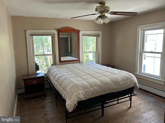 135-137 S 6th St, Shamokin, PA 17872 - bedroom with multiple windows, wood-type flooring, a baseboard heating unit, and a ceiling fan