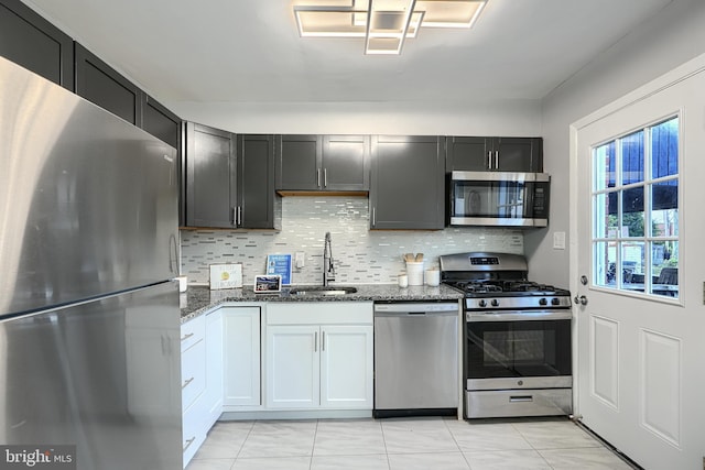 267 Southeastern Ter, Baltimore, MD 21221 - kitchen with appliances with stainless steel finishes, dark stone counters, and decorative backsplash