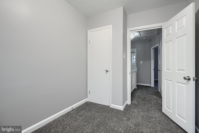 267 Southeastern Ter, Baltimore, MD 21221 - unfurnished bedroom with attic access and dark carpet