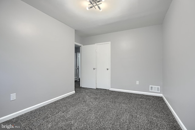 267 Southeastern Ter, Baltimore, MD 21221 - spare room featuring baseboards and dark colored carpet